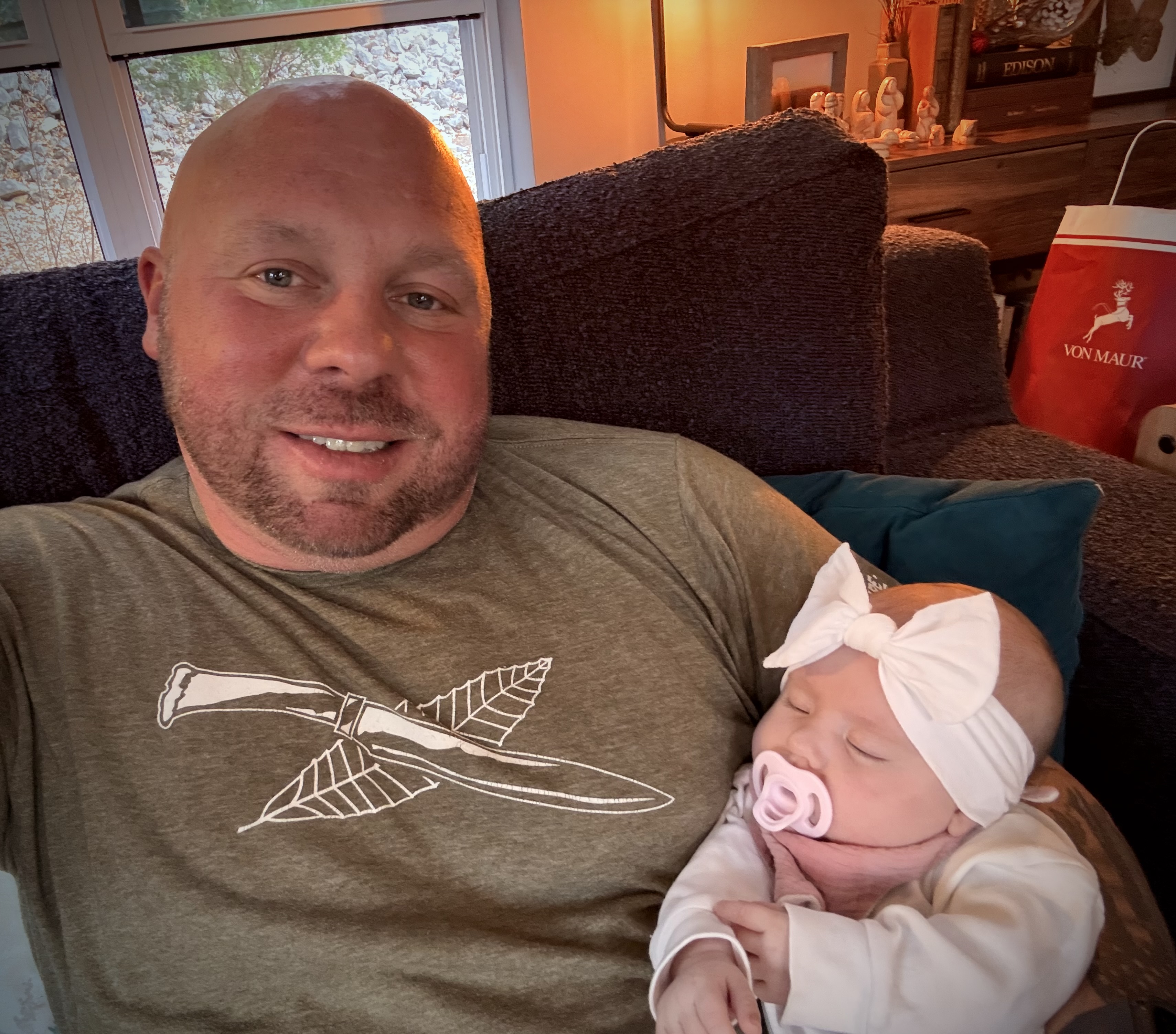 Grandfather lovingly holding baby Delilah